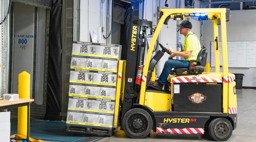 Forklift moving a pallet of boxes